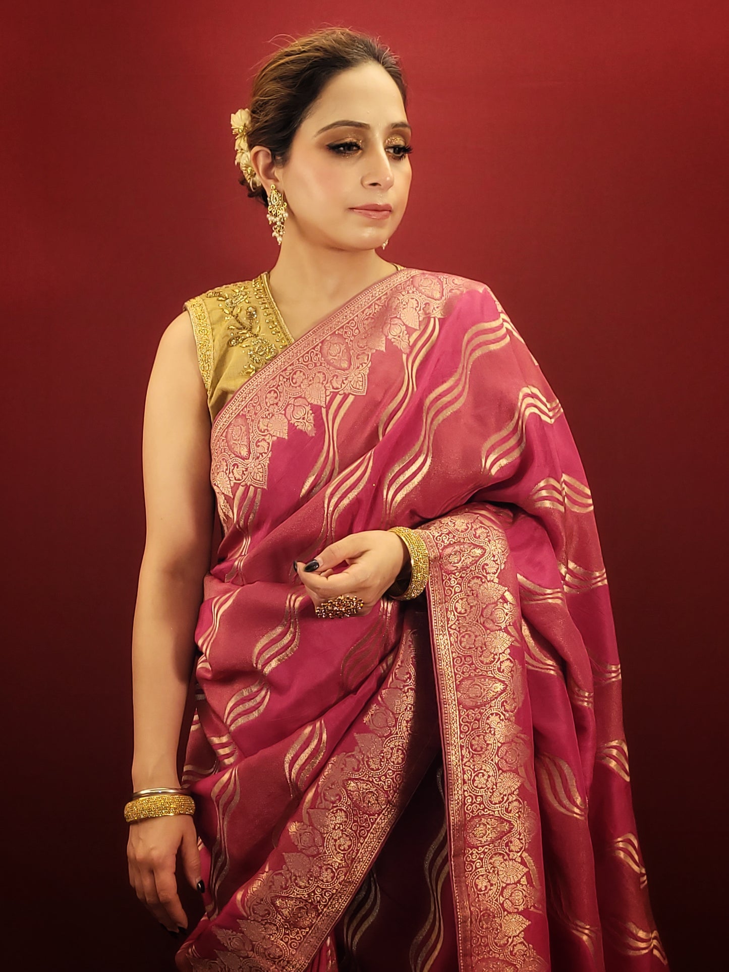 This stunning hot pink woven silk saree blends elegance with flair. It is perfect for party and wedding occasions.