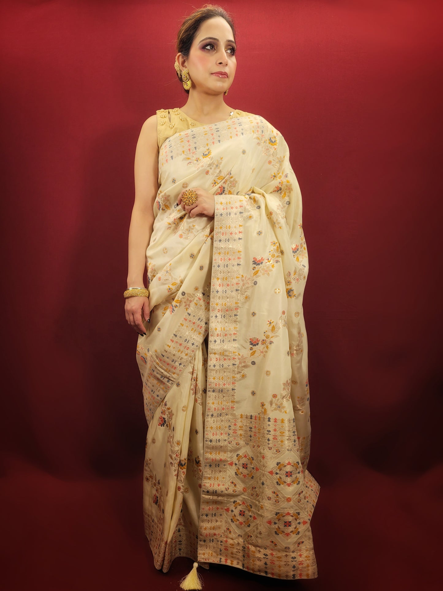 Embrace the festive spirit with a creme Banarasi woven saree, crafted from the finest silk to add a touch of traditional glamour to your party wear collection.