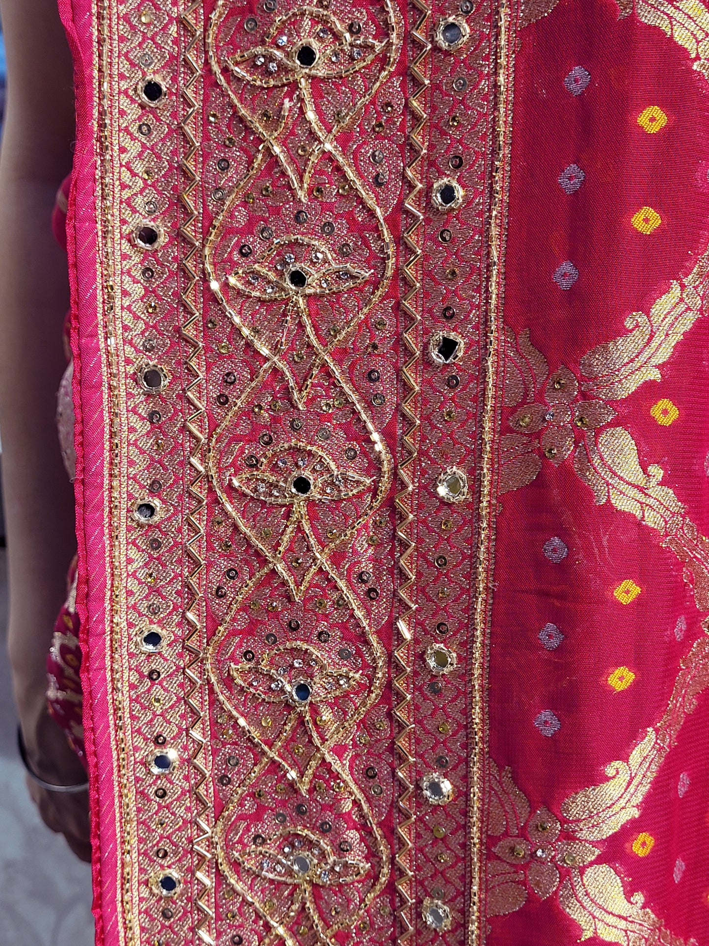Rani Pink Georgette Banarasi (Khaddi) Bandhni Handwork Saree. Cutdana, Mirror and Sequins highlighting work. Matching unstitched blouse piece included.