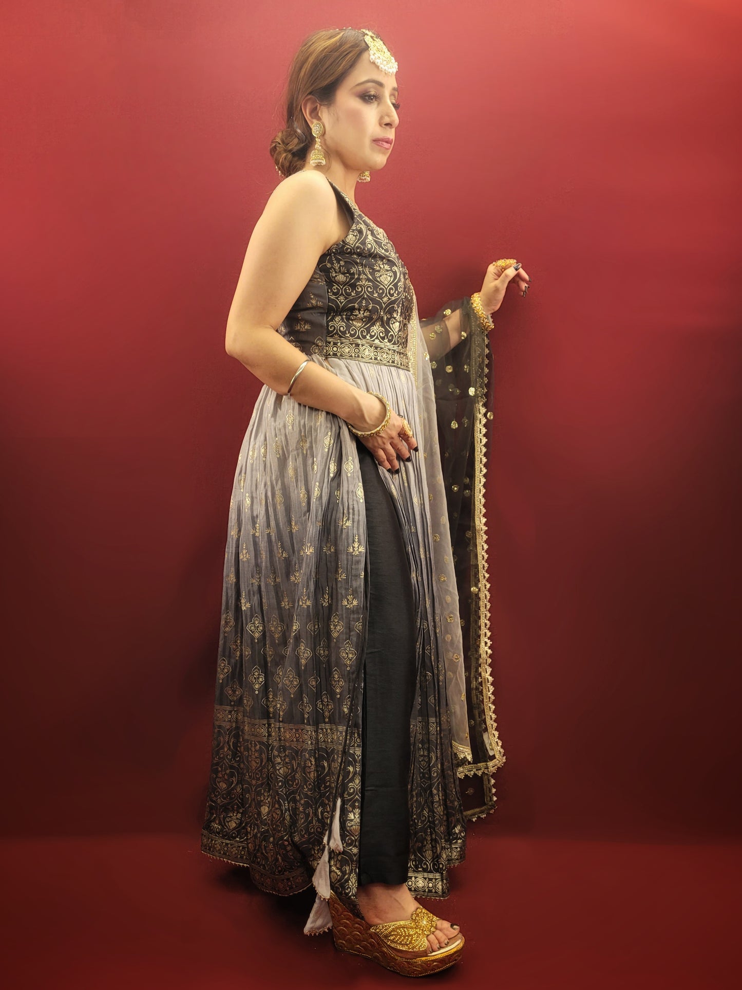 The Nayra suit, with its graceful grey ombre setting and chic Pant Set, is accentuated with traditional block prints and sparkling zarkan, crafted from flowing chinnon, making it a sophisticated ethnic ensemble for women's party wear.