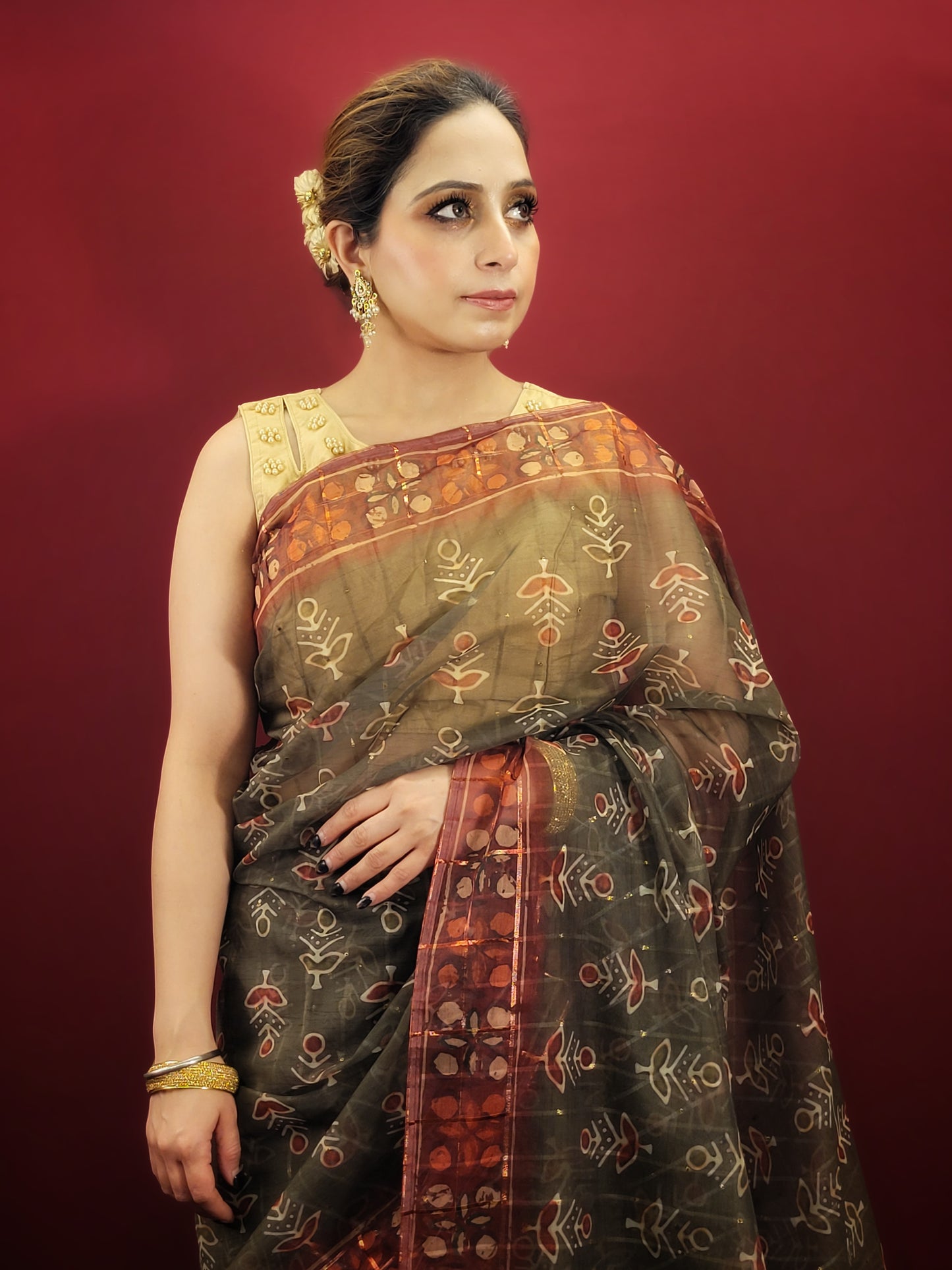 Embrace the grace of tradition with a mehendi green saree, adorned with exquisite organza and ajrakh prints, making it an ideal choice for party and festive wear.