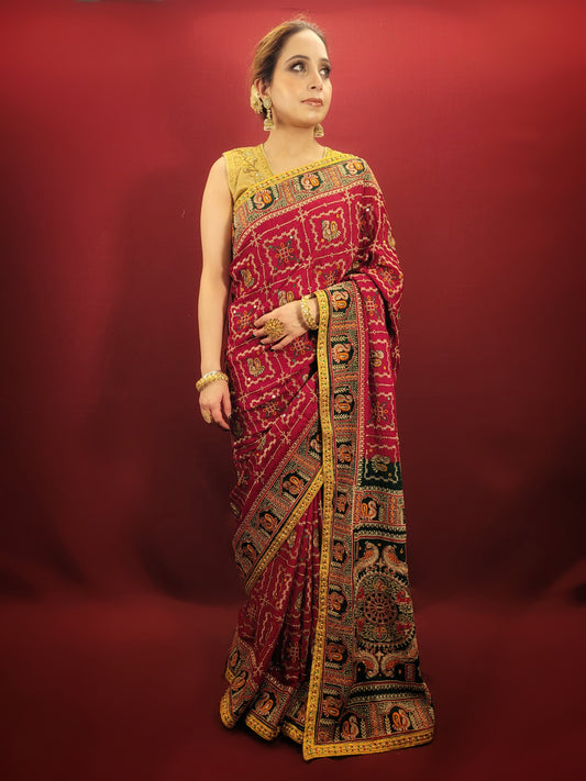 Take a look at this stunning maroon red ethnic saree with a green pallu that's perfect for weddings and bridal wear. The saree is made of gajji silk fabric and features intricate work using cutdana, thread, and zari. It's a beautiful piece that will surely catch everyone's eye.