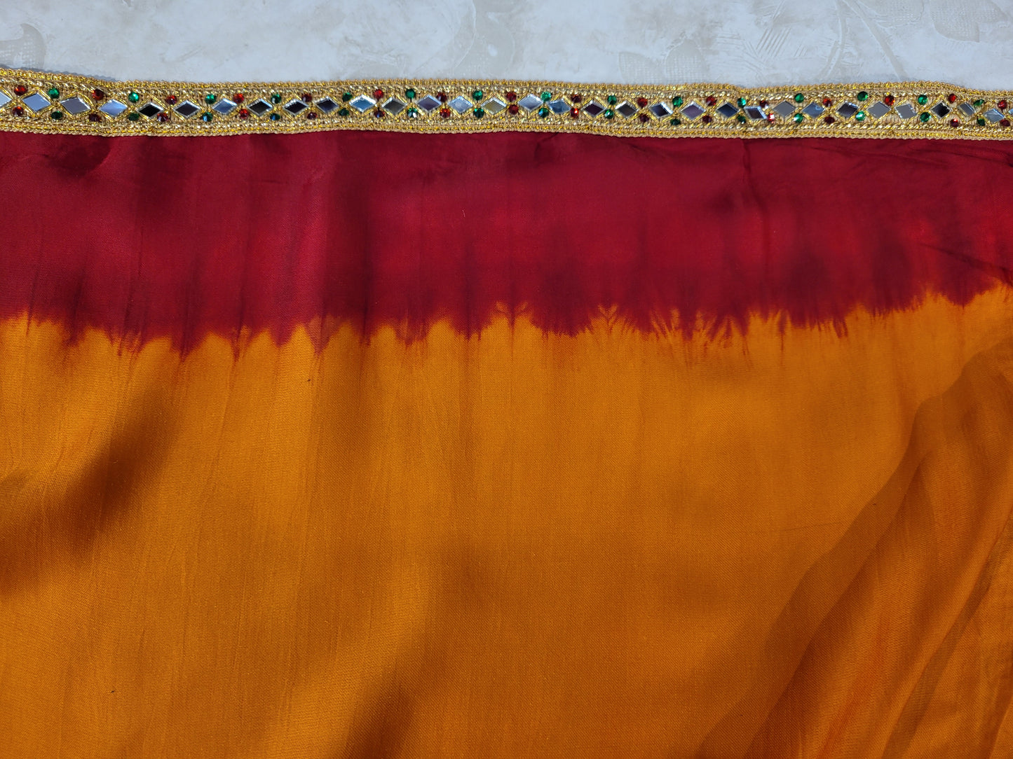 This beautiful mustard yellow silk saree with a beautiful maroon pallu that makes it stand out from the crowd. The saree features intricate cutdana, zari, and thread work that gives it a touch of elegance and class. This saree is perfect for any party, wedding, or even as a bridal wear.