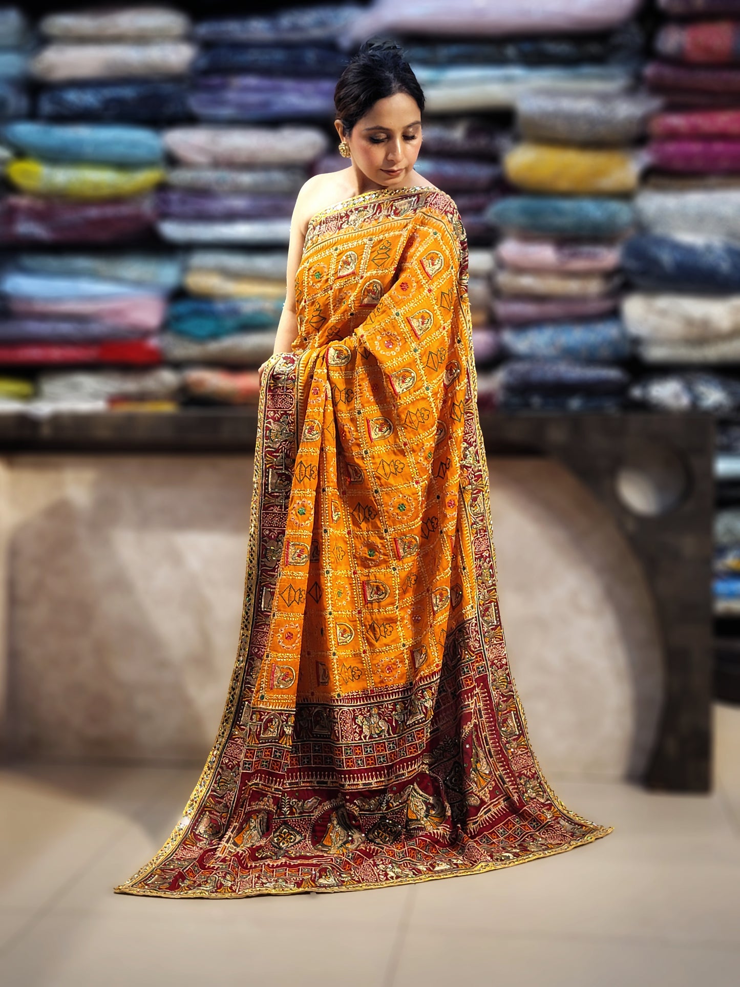 This beautiful mustard yellow silk saree with a beautiful maroon pallu that makes it stand out from the crowd. The saree features intricate cutdana, zari, and thread work that gives it a touch of elegance and class. This saree is perfect for any party, wedding, or even as a bridal wear.