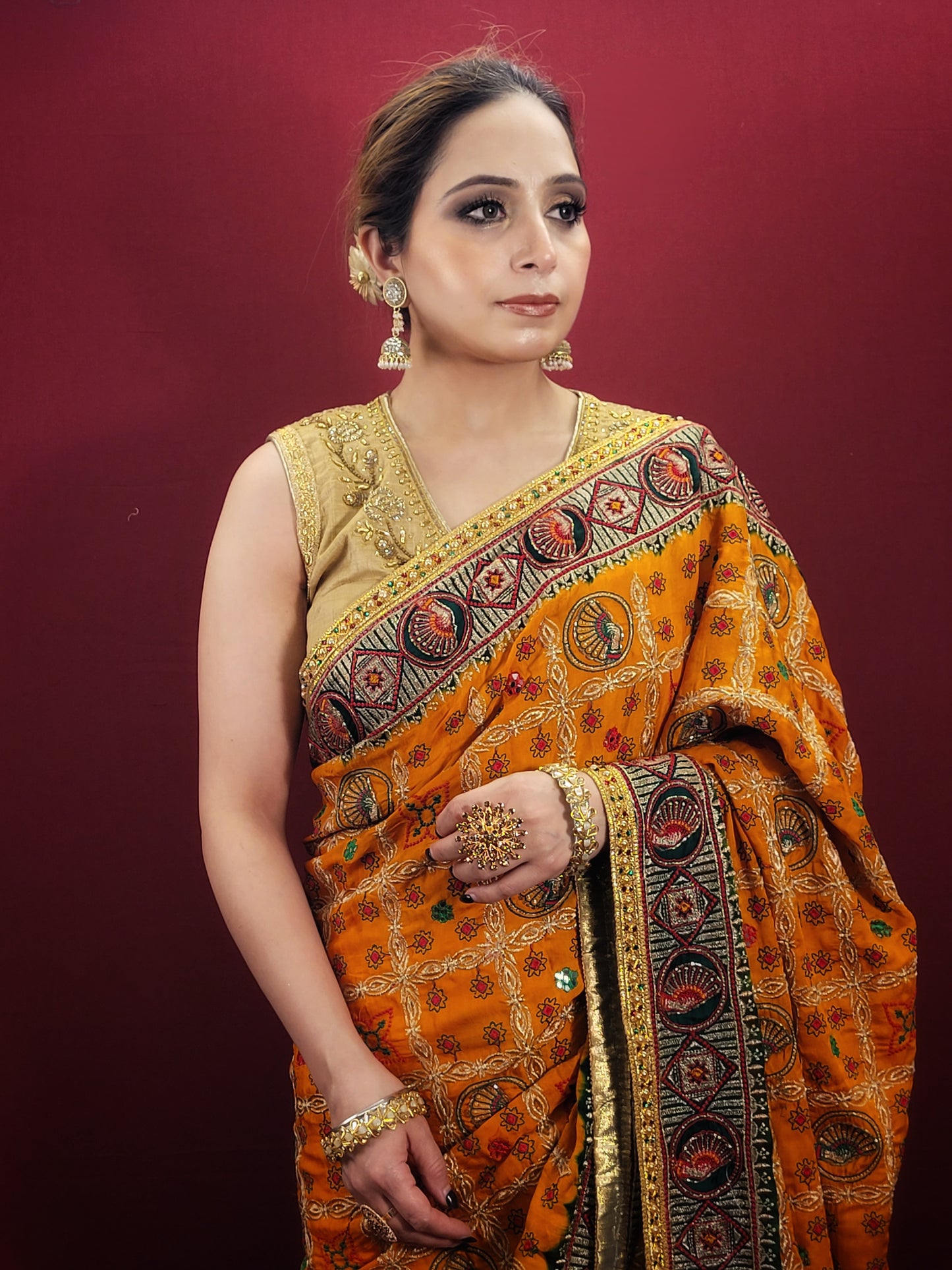 This gorgeous mustard yellow gajji silk saree with a beautiful green pallu that makes it stand out from the crowd. The saree features intricate cutdana, zari, and thread work that gives it a touch of elegance and class. This saree is perfect for any party, wedding, or even as a bridal wear.