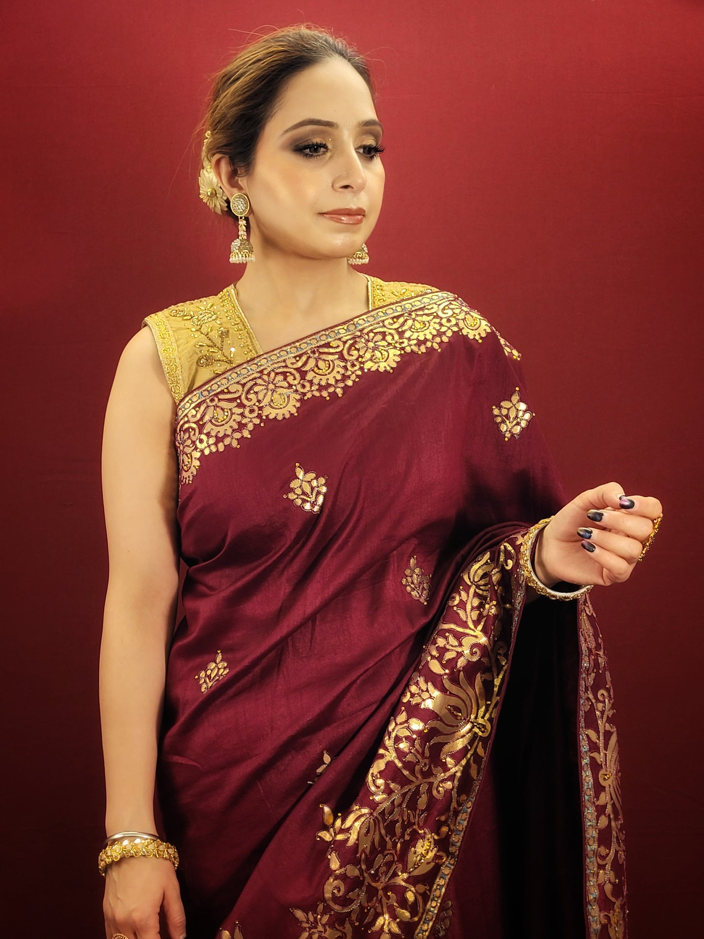 This wine silk saree with intricate gota patti work is perfect for any occasion, be it a party, a festival or a wedding. The rich wine color adds to its elegance and the gota patti work lends it a traditional touch.