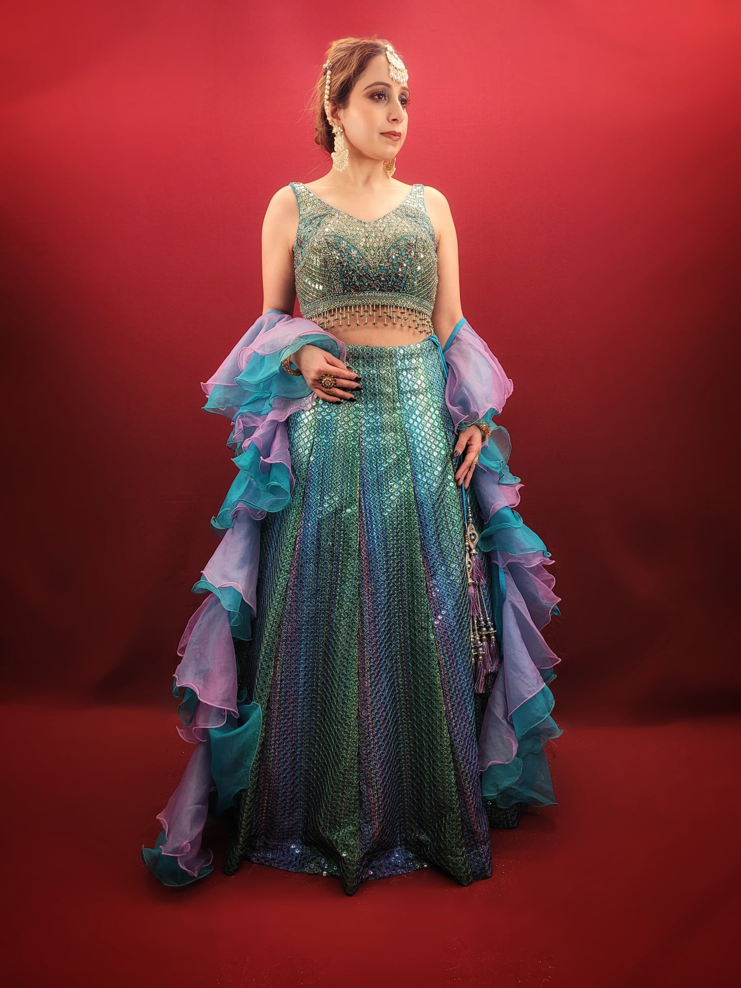 Introducing our stunning Shaded Teal Blue Lehenga Choli - the perfect choice for your upcoming special occasions. This exquisite ensemble features intricate beadwork, zardozi, and sequins on the choli, adding a touch of glamour and elegance to your overall look. Made from high-quality imported fabric, the lehenga choli is not only stylish but also comfortable to wear.