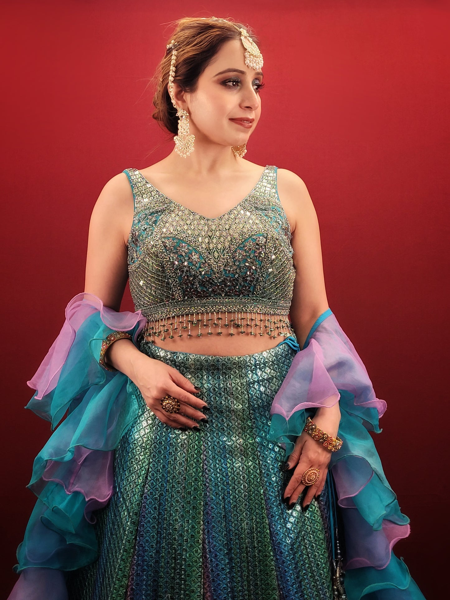 Introducing our stunning Shaded Teal Blue Lehenga Choli - the perfect choice for your upcoming special occasions. This exquisite ensemble features intricate beadwork, zardozi, and sequins on the choli, adding a touch of glamour and elegance to your overall look. Made from high-quality imported fabric, the lehenga choli is not only stylish but also comfortable to wear.