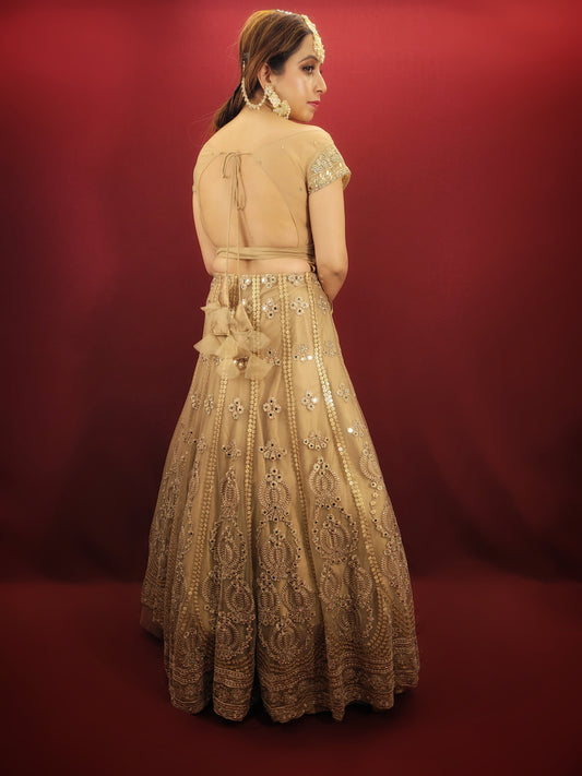 Bring a touch of luxury to your special day with this exquisite lehenga made with intricate golden net fabric, adorned with dazzling sequins and mirror work. The choli is also embellished with sequins, mirror, and zarkan work, while the matching net dupatta adds a final touch of elegance. Perfect for engagement and wedding parties, this lehenga is sure to make you feel like royalty.