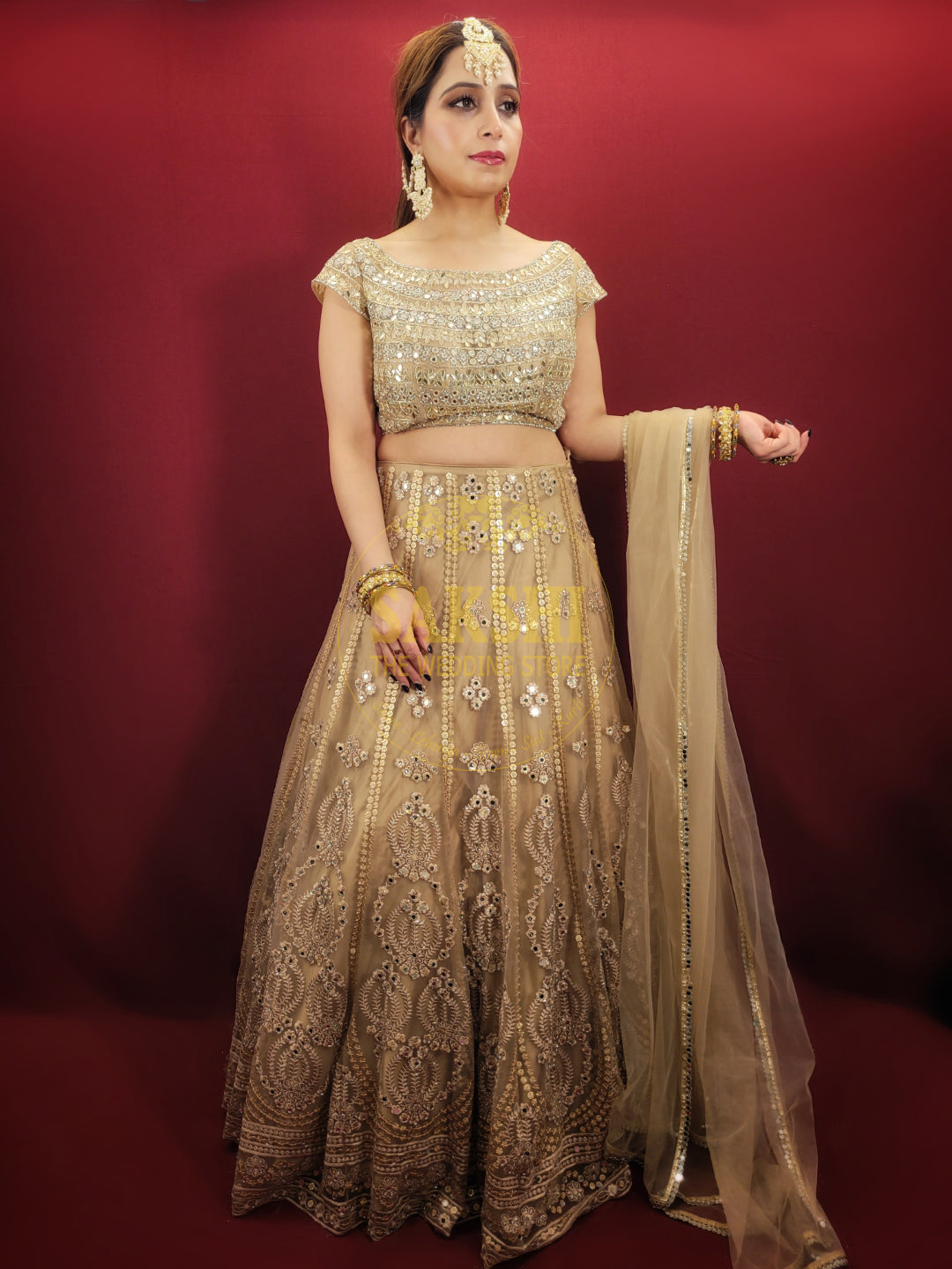 Bring a touch of luxury to your special day with this exquisite lehenga made with intricate golden net fabric, adorned with dazzling sequins and mirror work. The choli is also embellished with sequins, mirror, and zarkan work, while the matching net dupatta adds a final touch of elegance. Perfect for engagement and wedding parties, this lehenga is sure to make you feel like royalty.