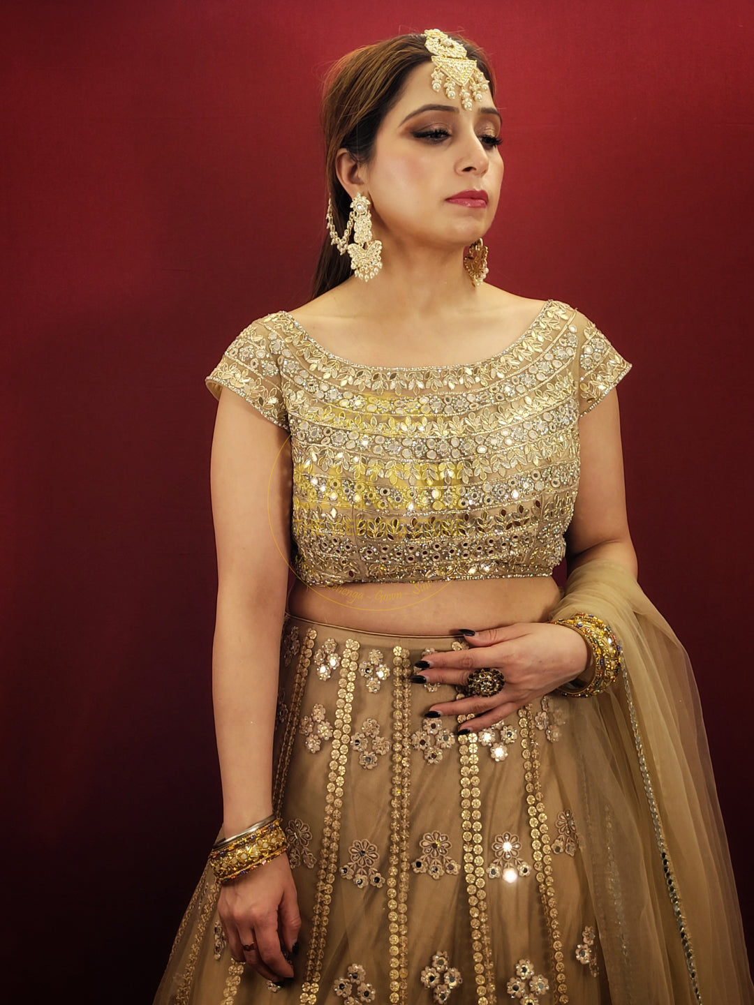 Bring a touch of luxury to your special day with this exquisite lehenga made with intricate golden net fabric, adorned with dazzling sequins and mirror work. The choli is also embellished with sequins, mirror, and zarkan work, while the matching net dupatta adds a final touch of elegance. Perfect for engagement and wedding parties, this lehenga is sure to make you feel like royalty.