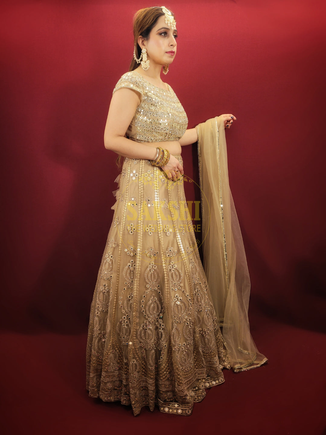 Bring a touch of luxury to your special day with this exquisite lehenga made with intricate golden net fabric, adorned with dazzling sequins and mirror work. The choli is also embellished with sequins, mirror, and zarkan work, while the matching net dupatta adds a final touch of elegance. Perfect for engagement and wedding parties, this lehenga is sure to make you feel like royalty.