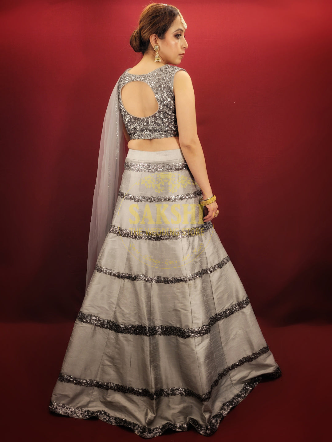 Expertly crafted with silver grey silk, this Lehenga features intricate cutdana beadwork and comes with a matching dupatta. Perfect for any party, it's sure to make you stand out with its elegant design. Elevate your style with this luxurious and timeless piece.
