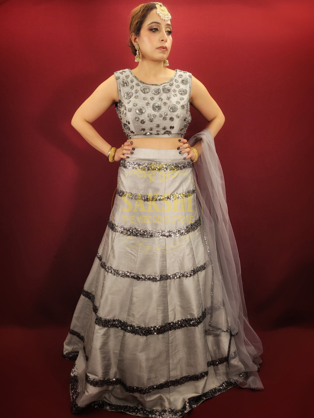Expertly crafted with silver grey silk, this Lehenga features intricate cutdana beadwork and comes with a matching dupatta. Perfect for any party, it's sure to make you stand out with its elegant design. Elevate your style with this luxurious and timeless piece.