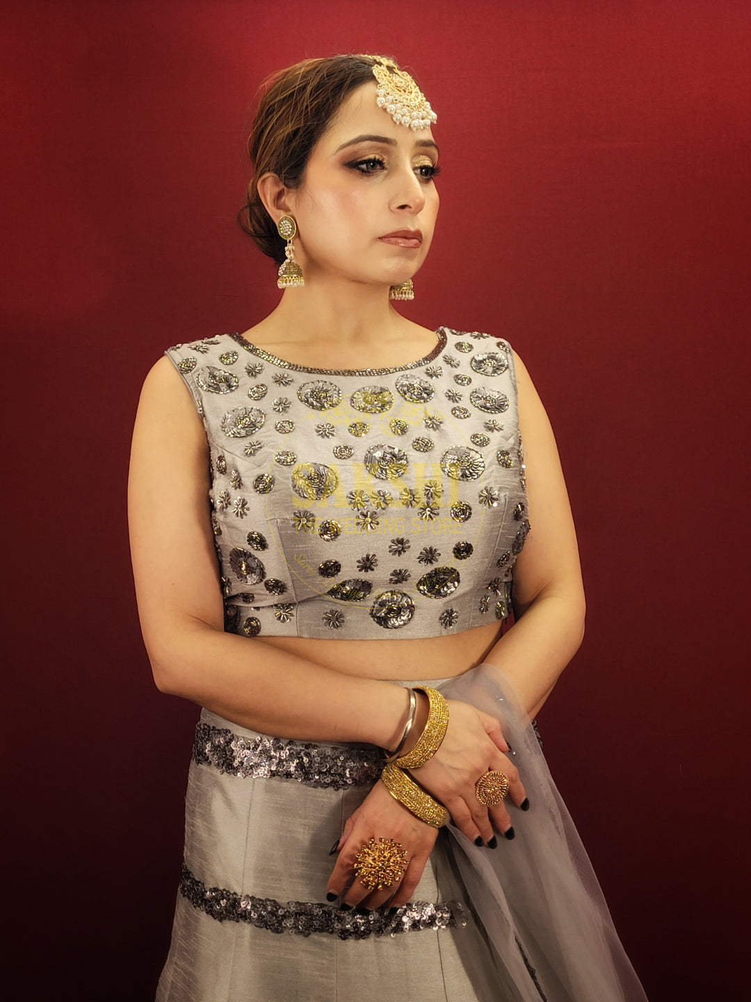 Expertly crafted with silver grey silk, this Lehenga features intricate cutdana beadwork and comes with a matching dupatta. Perfect for any party, it's sure to make you stand out with its elegant design. Elevate your style with this luxurious and timeless piece.