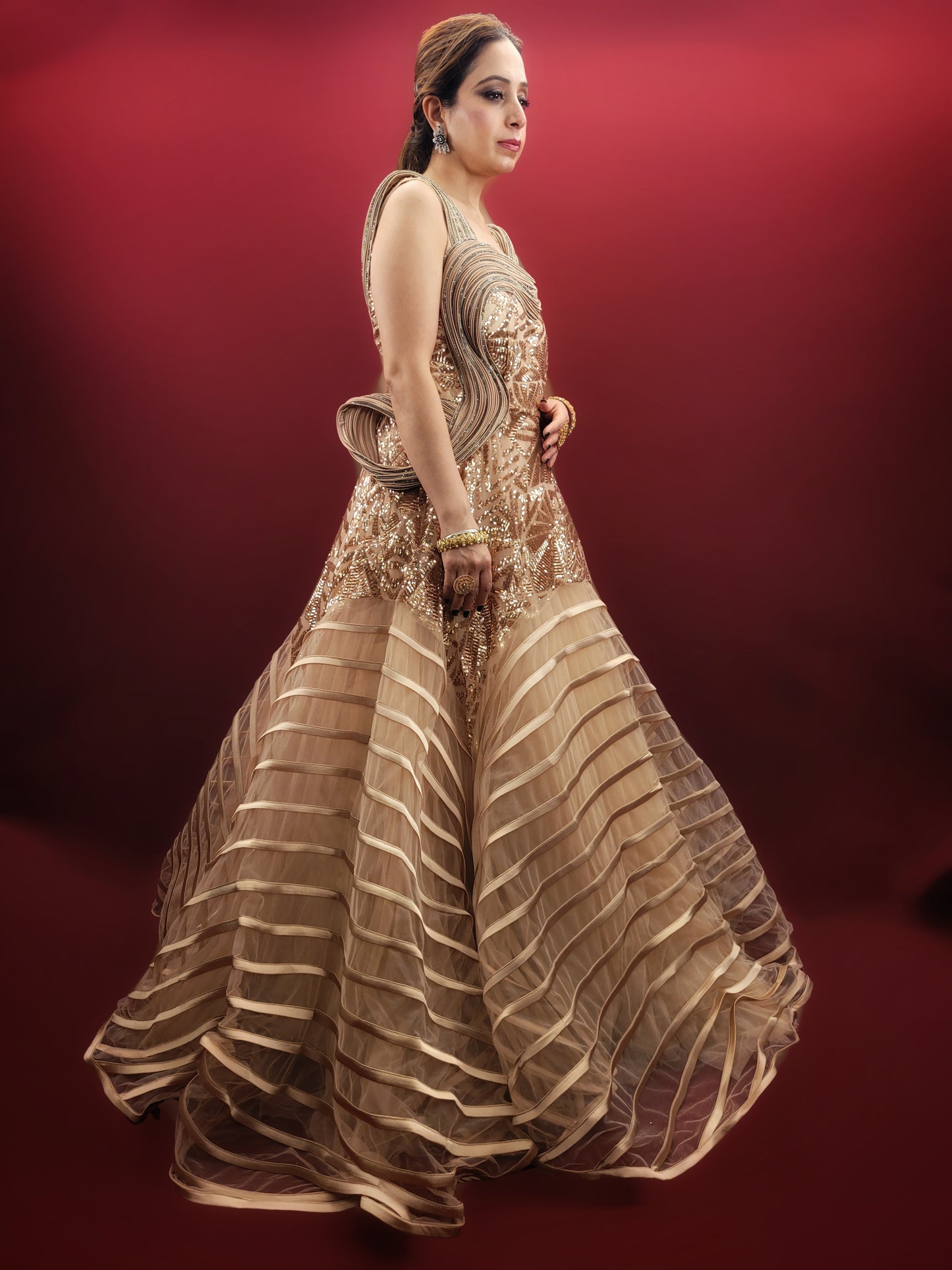 Embrace the drama and elegance of couture fashion with this Golden Beige Gown, inspired by the visionary designs of Gaurav Gupta. Crafted from delicate net fabric, this gown drapes effortlessly, creating a silhouette that is both ethereal and unforgettable.