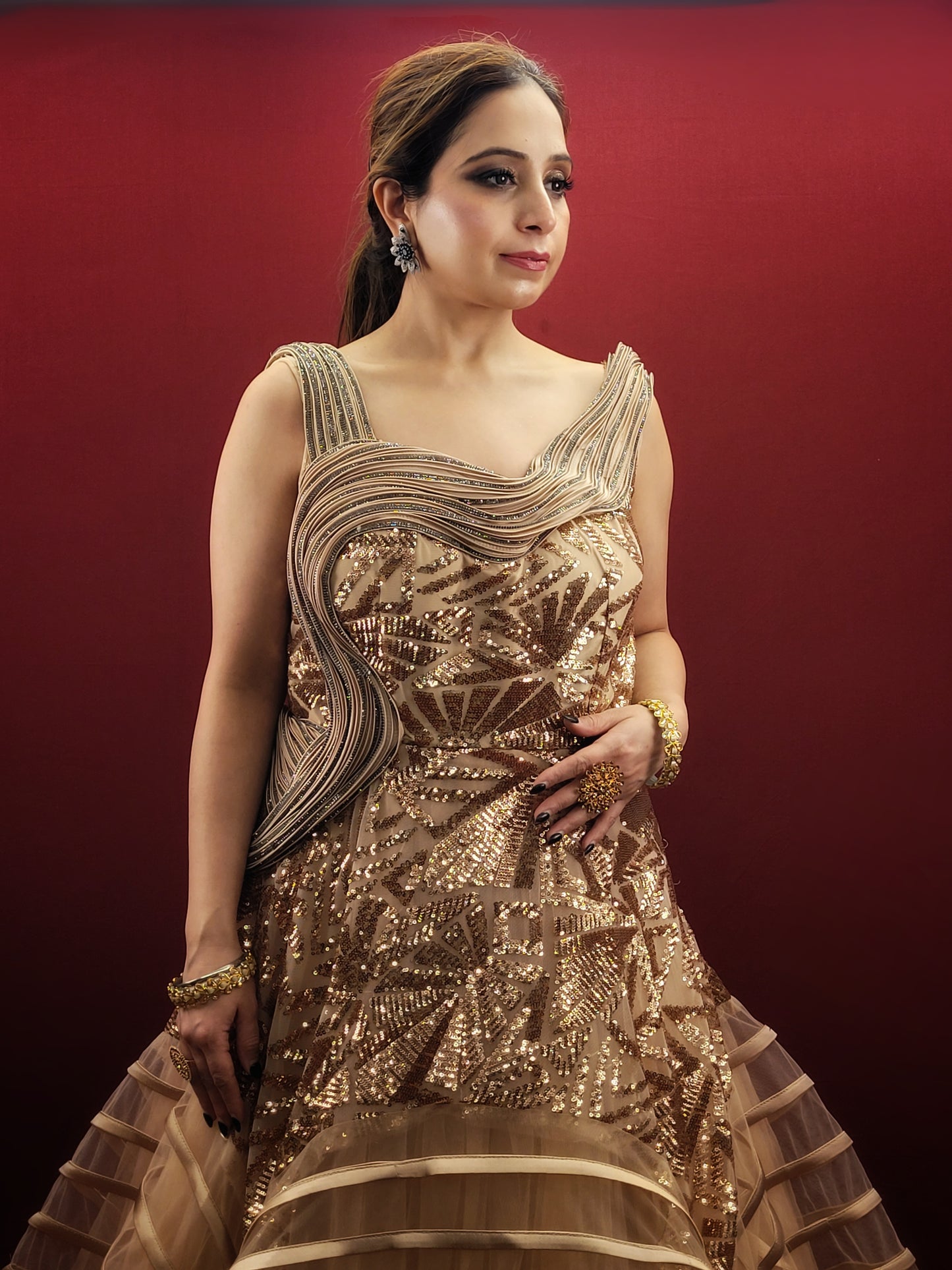 Embrace the drama and elegance of couture fashion with this Golden Beige Gown, inspired by the visionary designs of Gaurav Gupta. Crafted from delicate net fabric, this gown drapes effortlessly, creating a silhouette that is both ethereal and unforgettable.