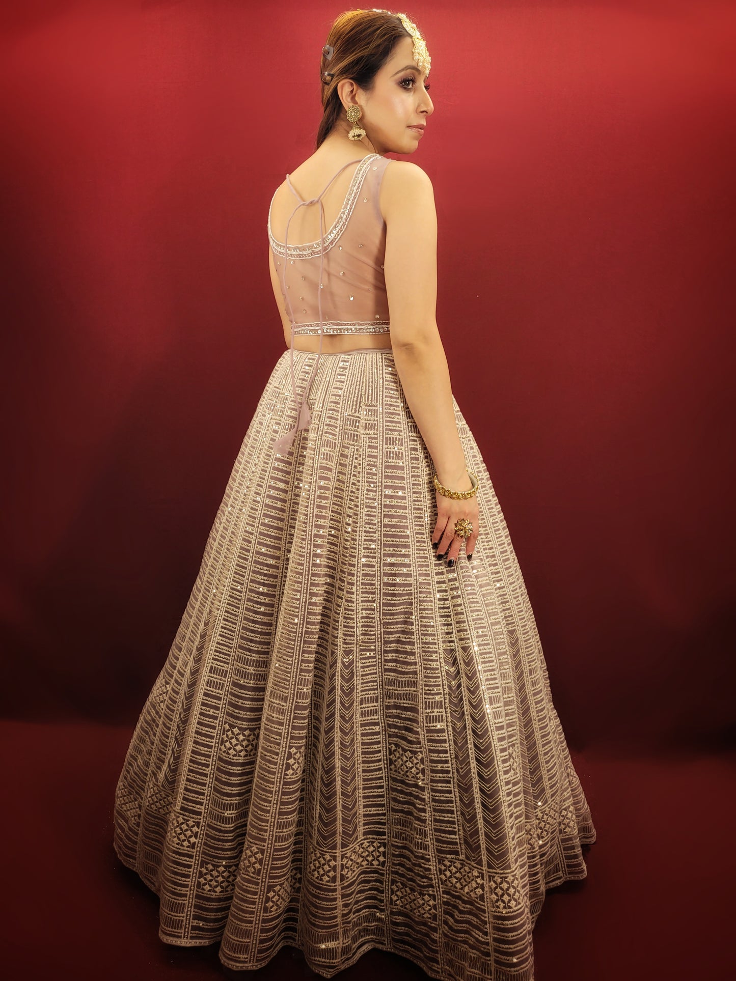 Embrace a captivating look for your engagement or any party with this stunning Net Lehenga Choli Set. Crafted from luxurious net fabric, this ready-to-wear ensemble drapes beautifully, ensuring effortless style and a touch of ethereal charm.