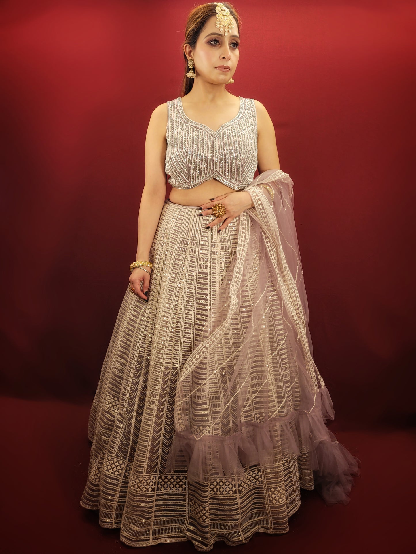 Embrace a captivating look for your engagement or any party with this stunning Net Lehenga Choli Set. Crafted from luxurious net fabric, this ready-to-wear ensemble drapes beautifully, ensuring effortless style and a touch of ethereal charm.