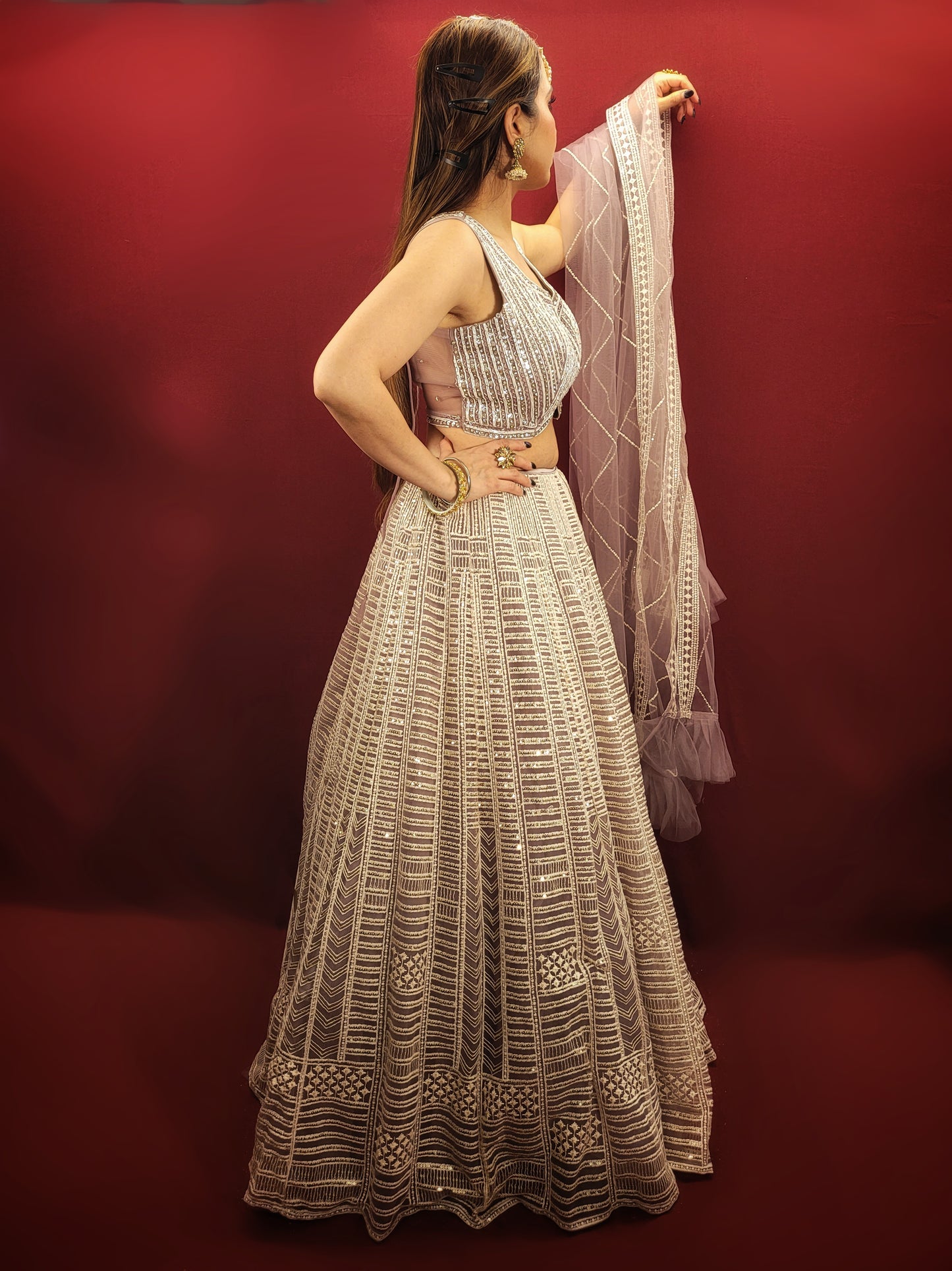 Embrace a captivating look for your engagement or any party with this stunning Net Lehenga Choli Set. Crafted from luxurious net fabric, this ready-to-wear ensemble drapes beautifully, ensuring effortless style and a touch of ethereal charm.