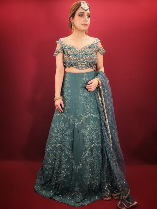 Immerse yourself in captivating elegance with this Ready-to-Wear Lehenga Choli Set in a mesmerizing Grand Canal Blue. Crafted from luxurious georgette fabric, this ensemble drapes effortlessly, ensuring a graceful silhouette and a touch of contemporary sophistication. Perfect for your engagement or any grand party, this outfit is sure to turn heads.