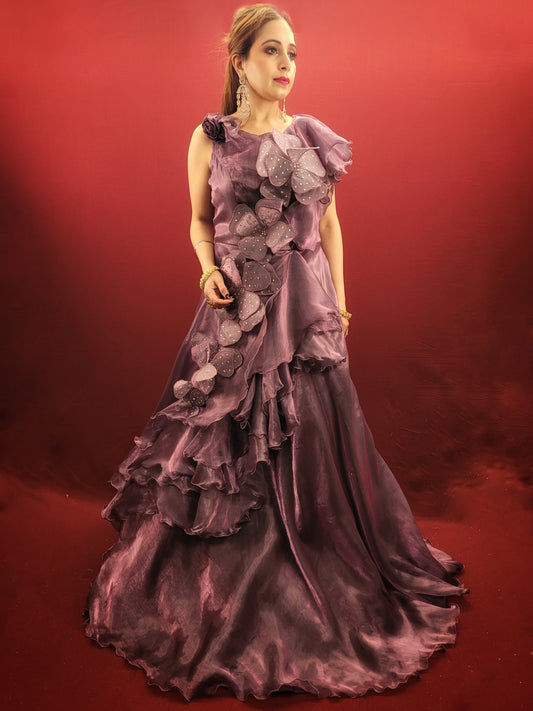 Embrace the magic of your engagement or reception in this breathtaking plum purple gown. Crafted from luxurious Jimmy Choo fabric, this dress promises a touch of unparalleled luxury against your skin. The gown features a captivating design, adorned with a sculpted flower that adds a touch of whimsical romance.