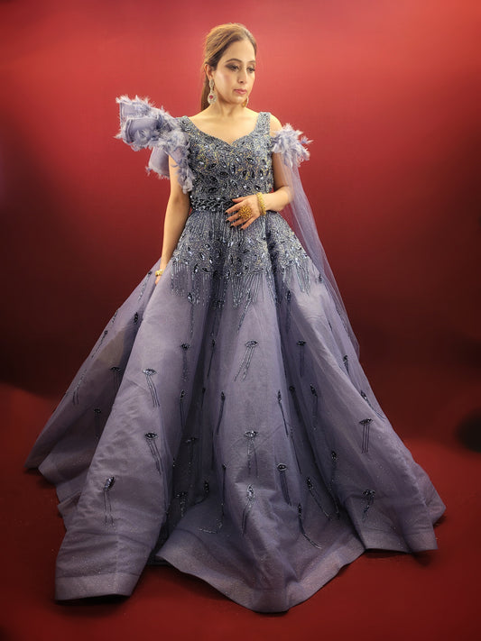 Embrace a vision of ethereal beauty in this stunning dark periwinkle ball gown, crafted from luxurious organza fabric. This designer gown is perfect for the bride who seeks a unique and captivating look for her engagement, cocktail party, or reception.