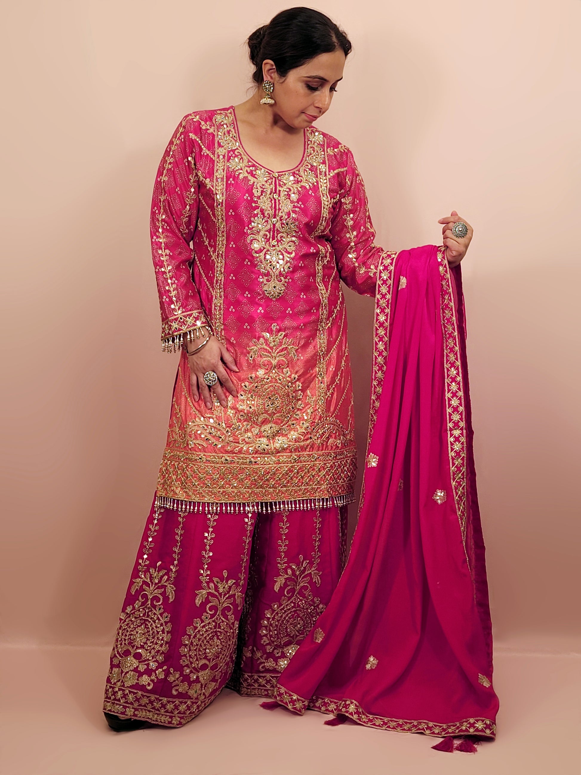 Rani Pink and Orange Shaded Kameez. Rani Sharara and Dupatta. Heavy Embroidery. Zari, Sequins and Mirror.