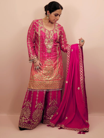 Rani Pink and Orange Shaded Kameez. Rani Sharara and Dupatta. Heavy Embroidery. Zari, Sequins and Mirror.