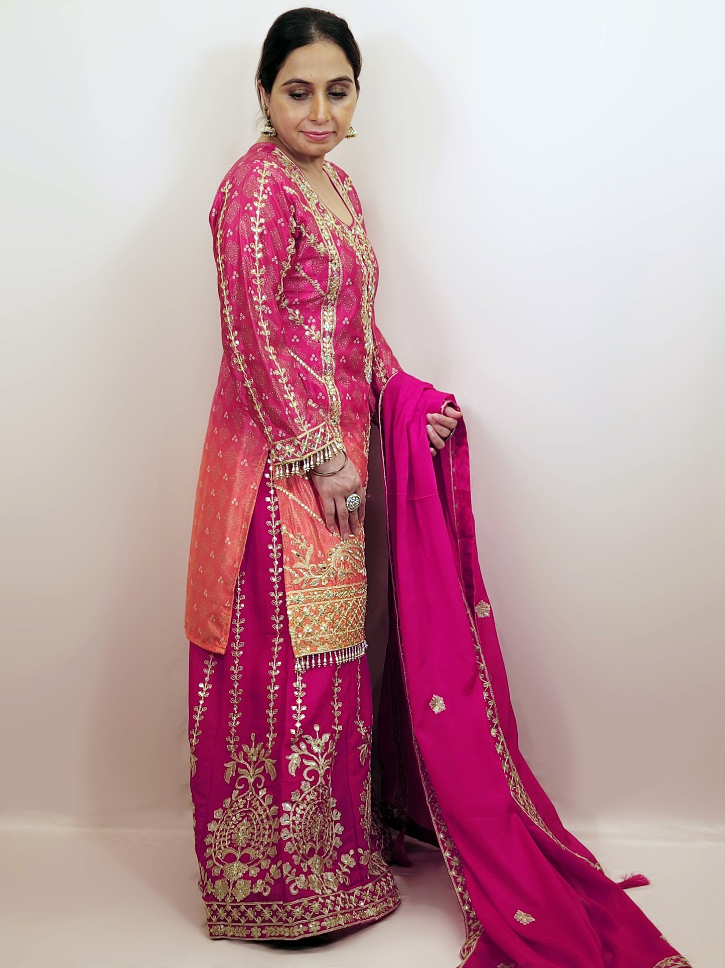 Rani Pink and Orange Shaded Kameez. Rani Sharara and Dupatta. Heavy Embroidery. Zari, Sequins and Mirror.