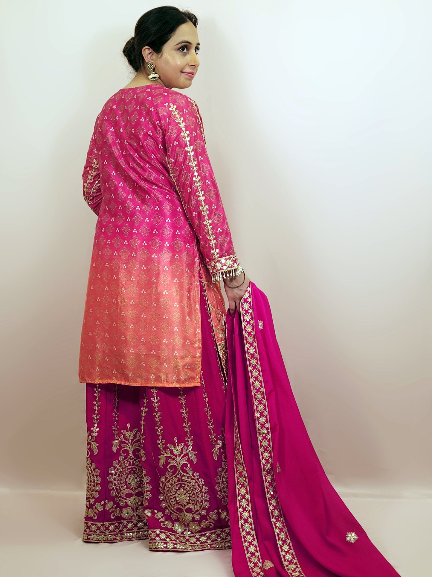Rani Pink and Orange Shaded Kameez. Rani Sharara and Dupatta. Heavy Embroidery. Zari, Sequins and Mirror.