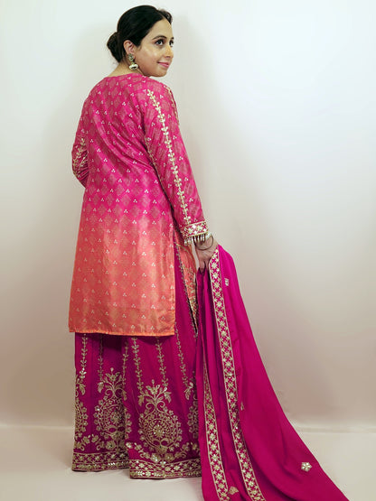 Rani Pink and Orange Shaded Kameez. Rani Sharara and Dupatta. Heavy Embroidery. Zari, Sequins and Mirror.