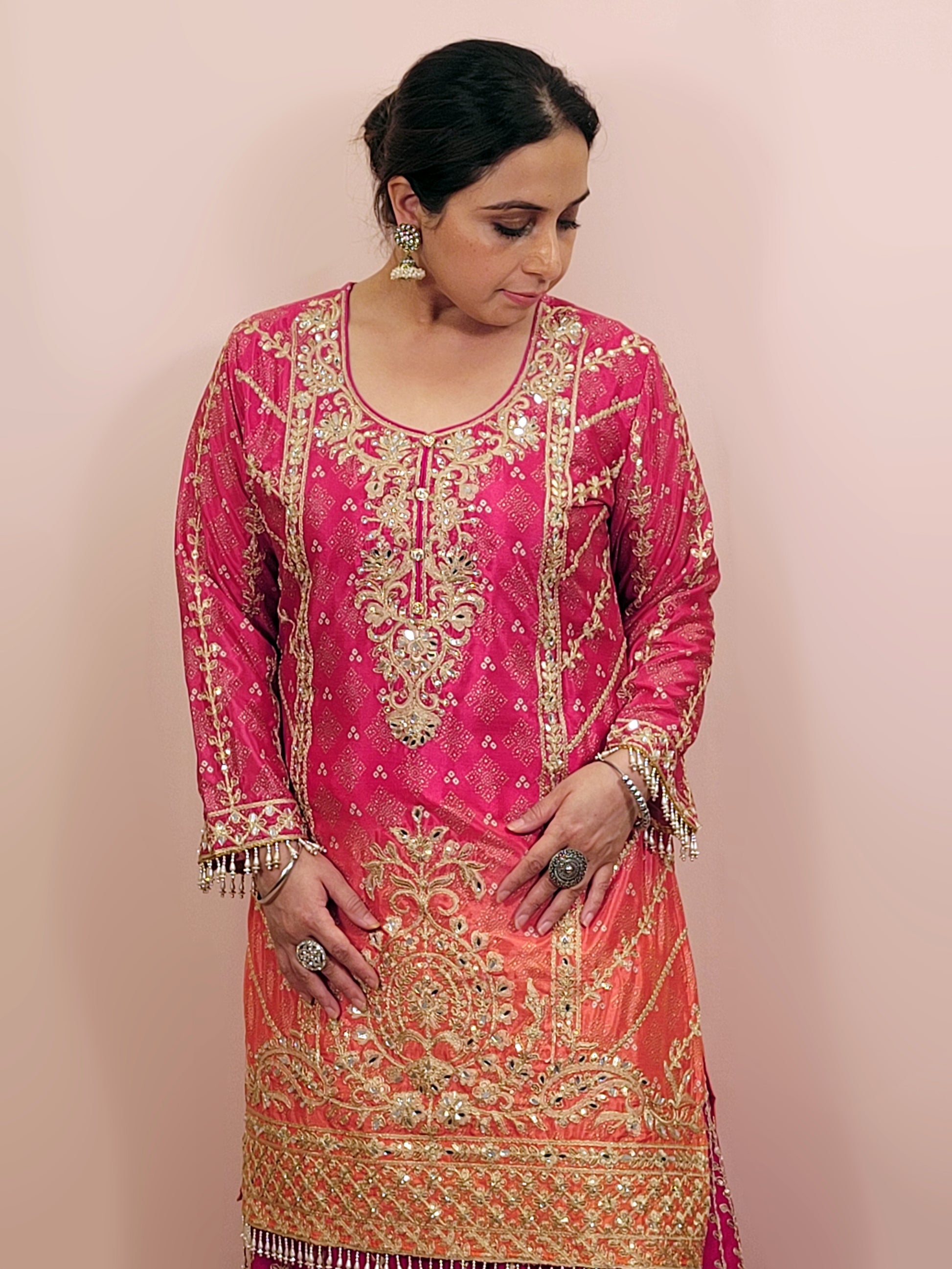 Rani Pink and Orange Shaded Kameez. Rani Sharara and Dupatta. Heavy Embroidery. Zari, Sequins and Mirror.