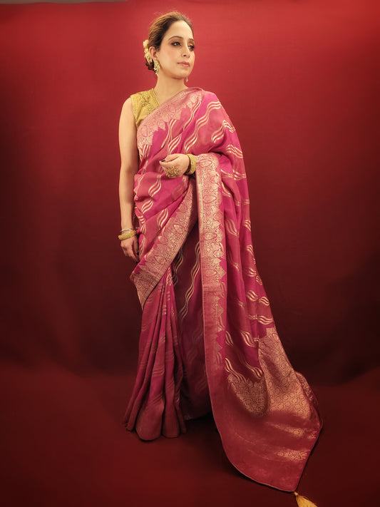 This stunning hot pink woven silk saree blends elegance with flair. It is perfect for party and wedding occasions.
