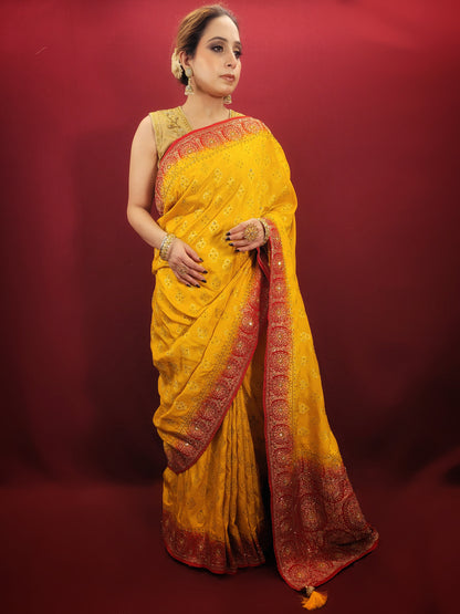 This beautiful yellow silk saree adorned with intricate zardosi and jarkan work is the perfect choice for a grand wedding celebration.
