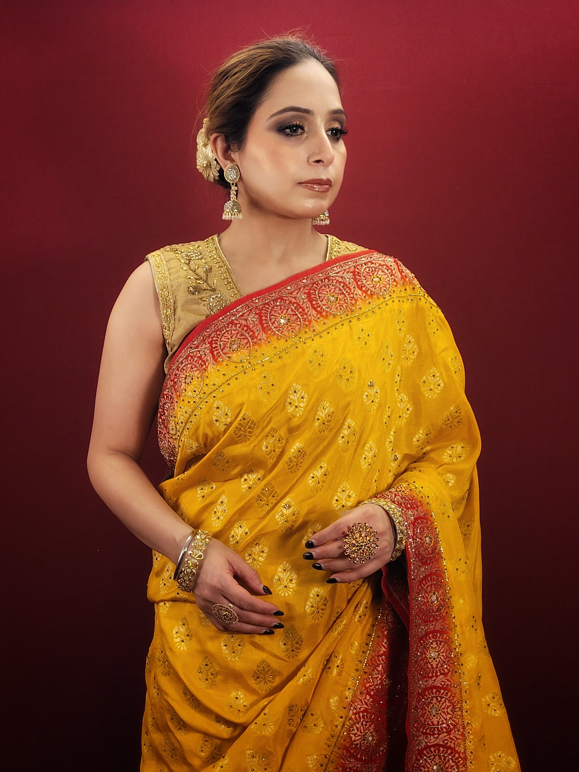 This beautiful yellow silk saree adorned with intricate zardosi and jarkan work is the perfect choice for a grand wedding celebration.