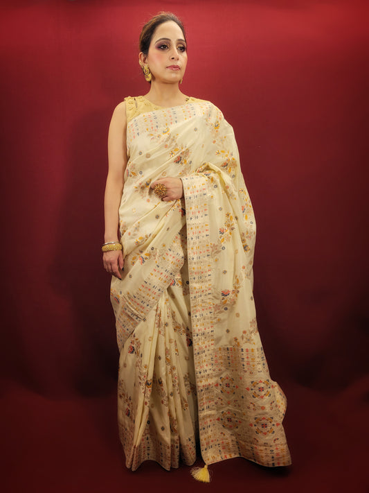 Embrace the festive spirit with a creme Banarasi woven saree, crafted from the finest silk to add a touch of traditional glamour to your party wear collection.