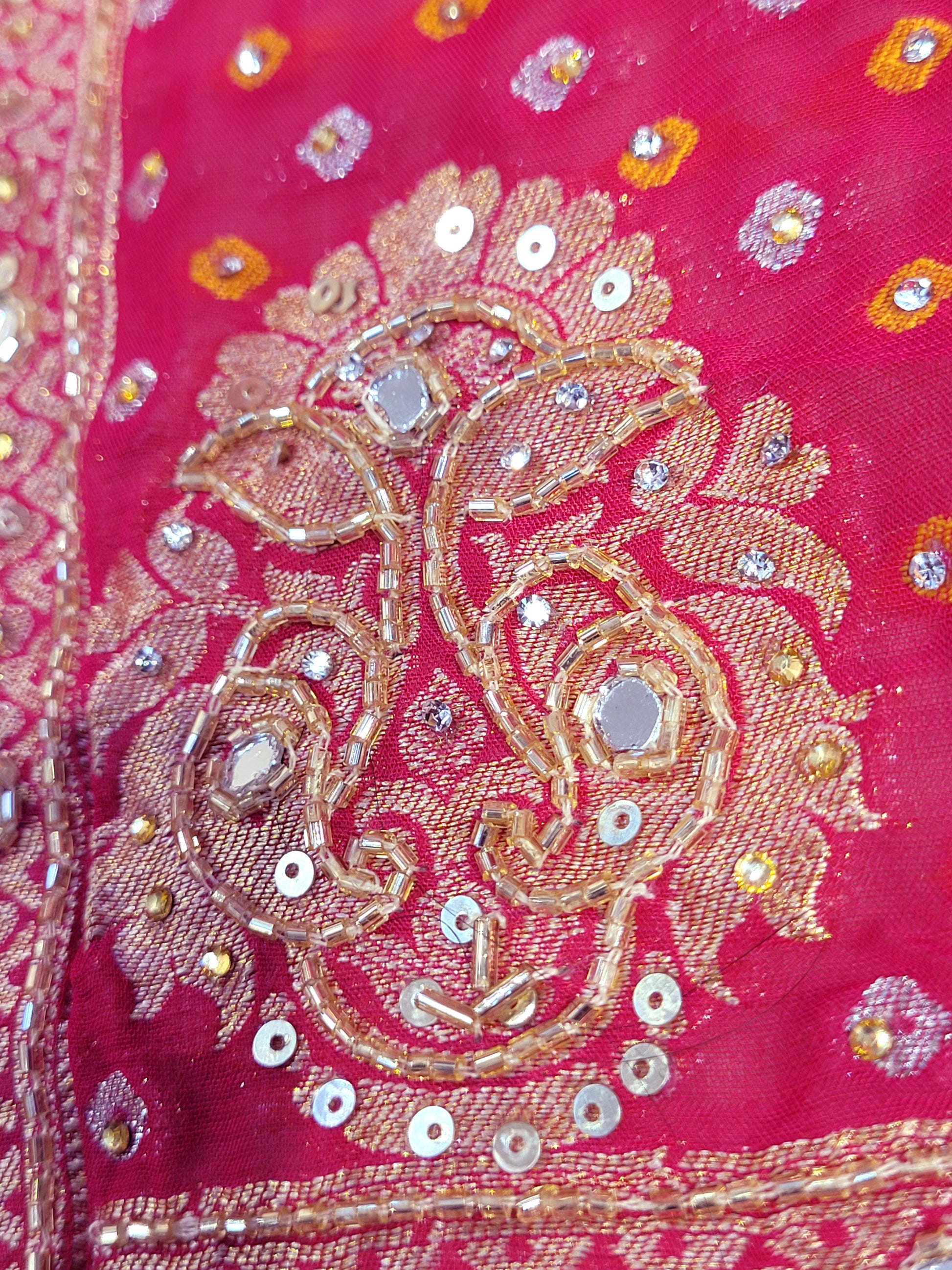 Rani Pink Georgette Banarasi (Khaddi) Bandhni Handwork Saree. Cutdana, Mirror and Sequins highlighting work. Matching unstitched blouse piece included.