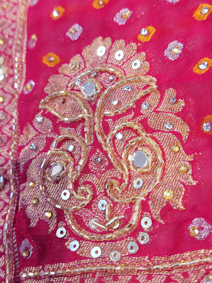 Rani Pink Georgette Banarasi (Khaddi) Bandhni Handwork Saree. Cutdana, Mirror and Sequins highlighting work. Matching unstitched blouse piece included.