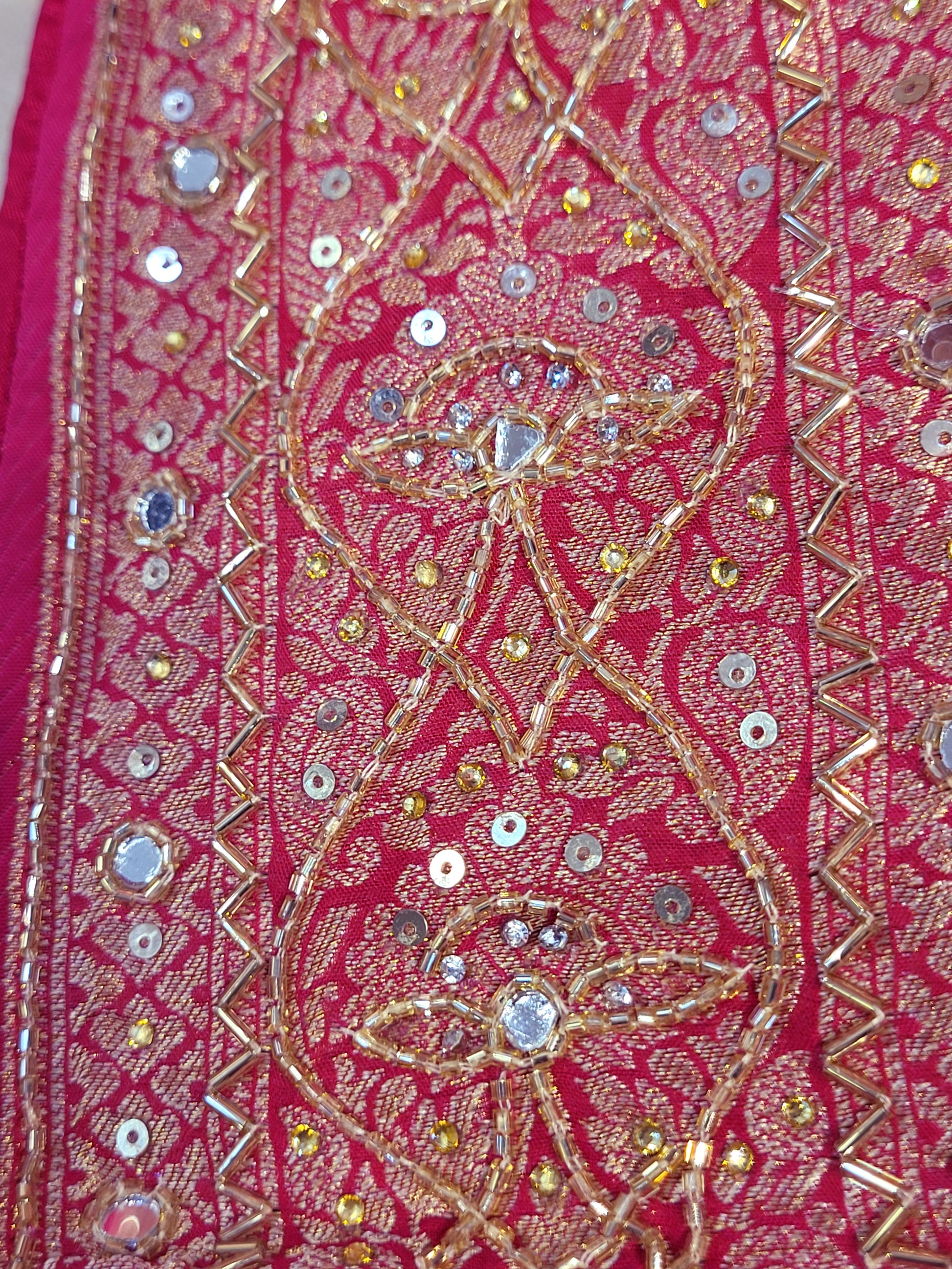 Rani Pink Georgette Banarasi (Khaddi) Bandhni Handwork Saree. Cutdana, Mirror and Sequins highlighting work. Matching unstitched blouse piece included.
