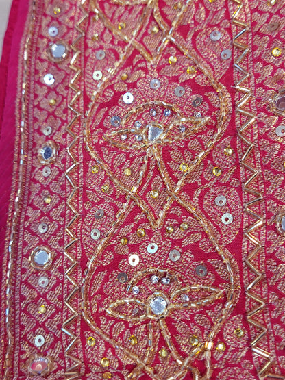 Rani Pink Georgette Banarasi (Khaddi) Bandhni Handwork Saree. Cutdana, Mirror and Sequins highlighting work. Matching unstitched blouse piece included.