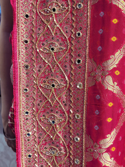 Rani Pink Georgette Banarasi (Khaddi) Bandhni Handwork Saree. Cutdana, Mirror and Sequins highlighting work. Matching unstitched blouse piece included.