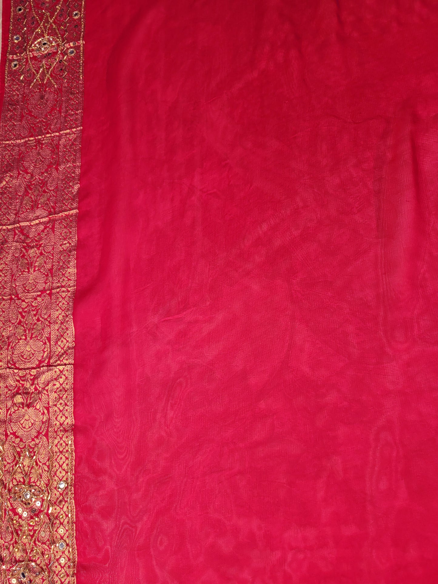 Rani Pink Georgette Banarasi (Khaddi) Bandhni Handwork Saree. Cutdana, Mirror and Sequins highlighting work. Matching unstitched blouse piece included.