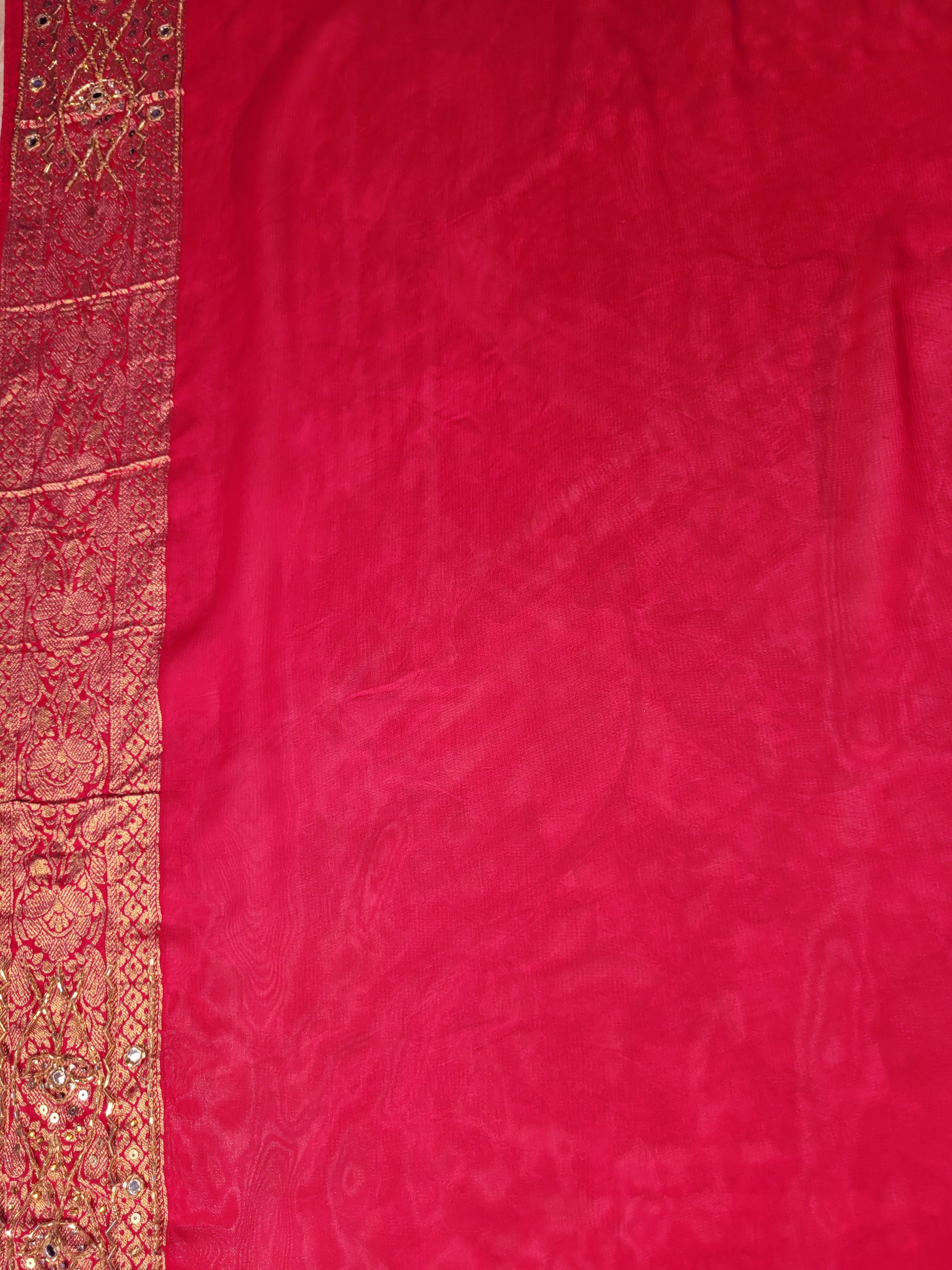 Rani Pink Georgette Banarasi (Khaddi) Bandhni Handwork Saree. Cutdana, Mirror and Sequins highlighting work. Matching unstitched blouse piece included.