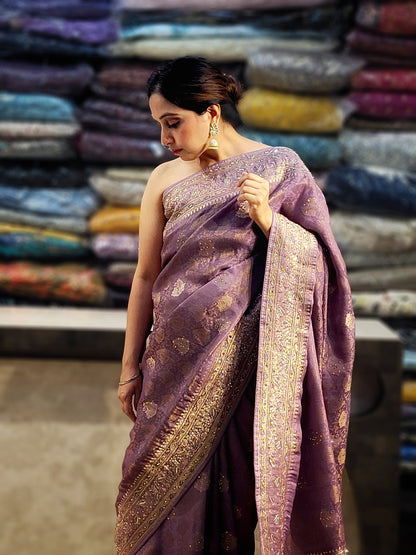 Shimmer Tissue Lavender Handwork Saree. Weaves highlighted with handwork using Dabka, Sequins, Mirror and Resham. Unstitched Blouse Piece included.
