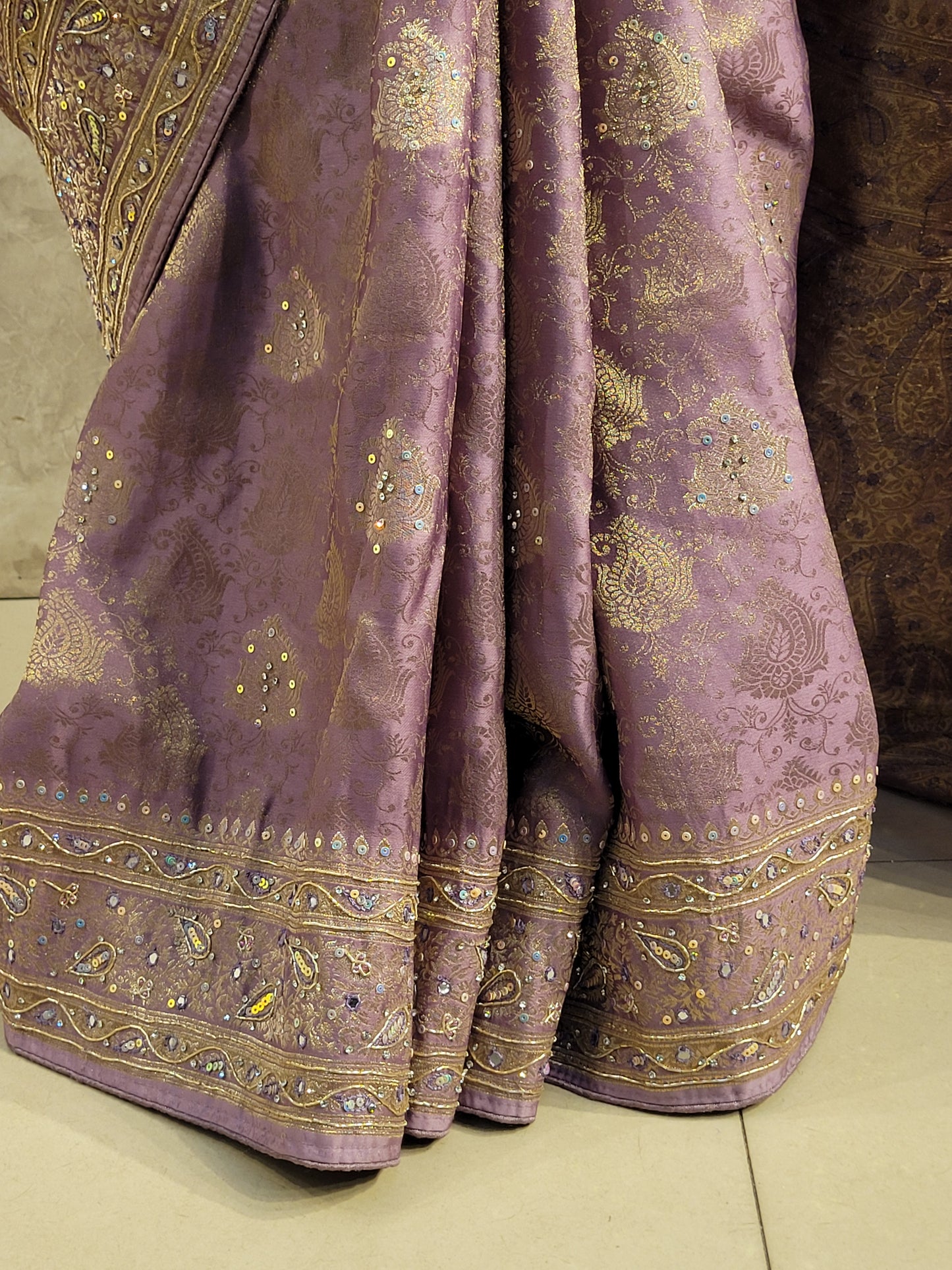 Shimmer Tissue Lavender Handwork Saree. Weaves highlighted with handwork using Dabka, Sequins, Mirror and Resham. Unstitched Blouse Piece included.