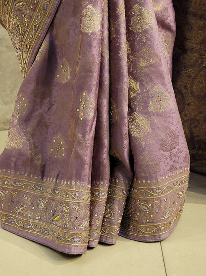 Shimmer Tissue Lavender Handwork Saree. Weaves highlighted with handwork using Dabka, Sequins, Mirror and Resham. Unstitched Blouse Piece included.