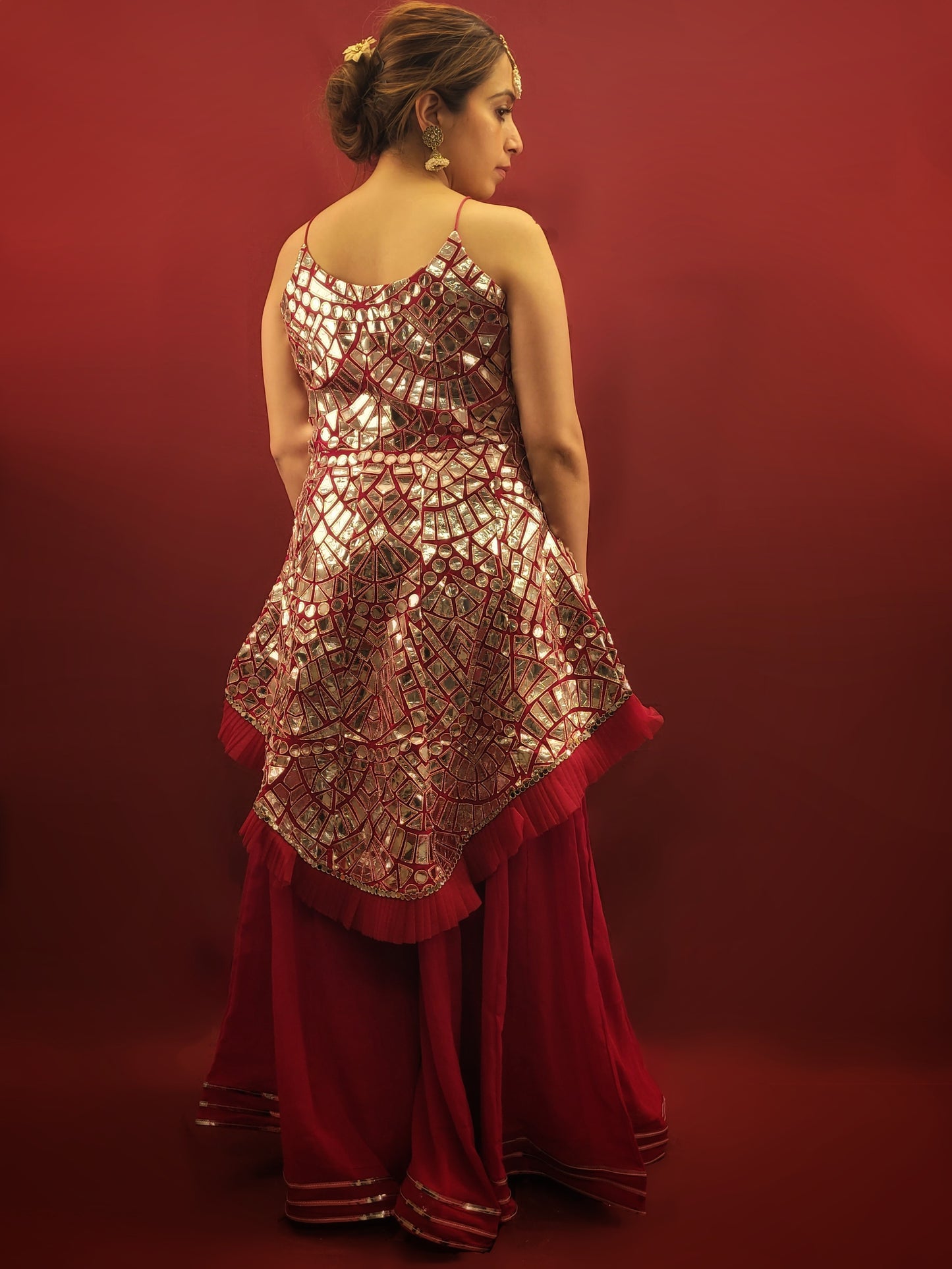 Drape yourself in a magenta indo-western Sharara adorned with intricate foil mirror work on flowy georgette, perfect for making a statement at any party wear occasion.