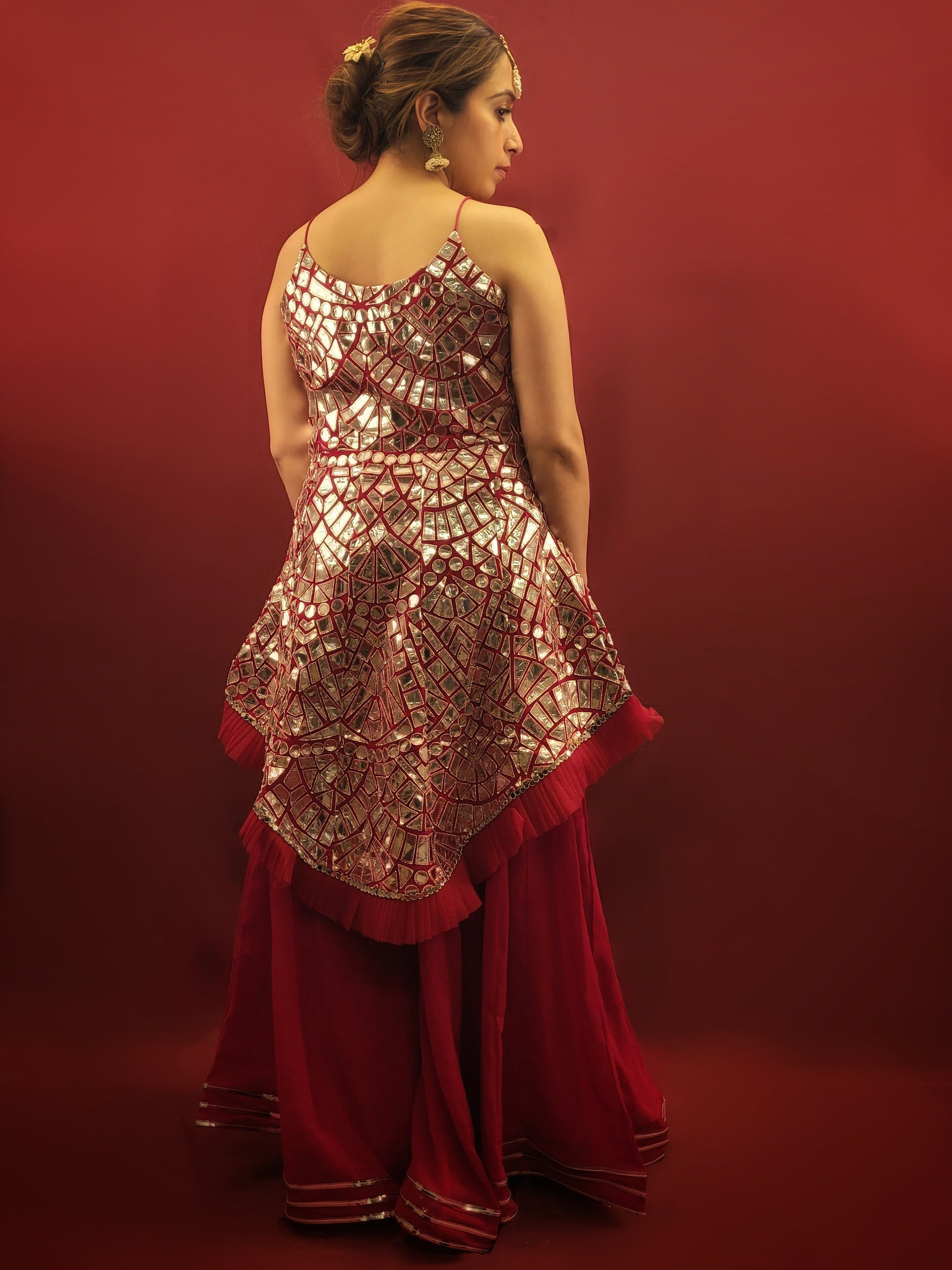 Drape yourself in a magenta indo-western Sharara adorned with intricate foil mirror work on flowy georgette, perfect for making a statement at any party wear occasion.