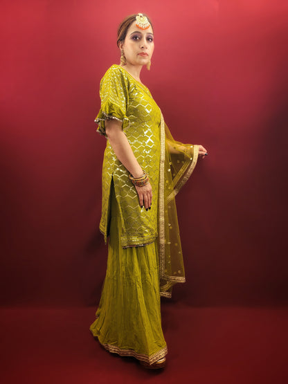 Embrace elegance with a mehendi green sharara set, featuring a dazzling sequins work and a beads & zari embellished neckline, crafted from luxurious chinnon fabric for a quintessential Indian ethnic wear ensemble.